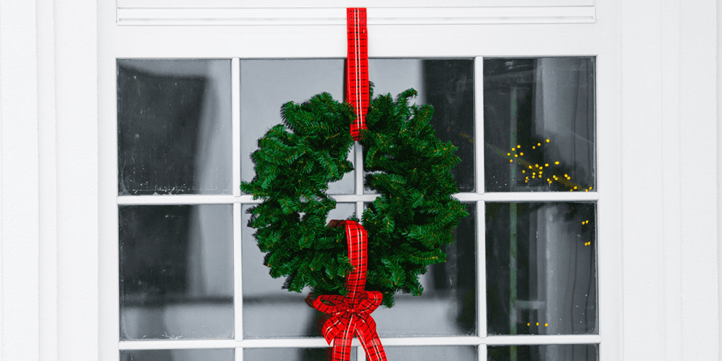 Platt Hill Nursery wreath hanging from ribbon on door