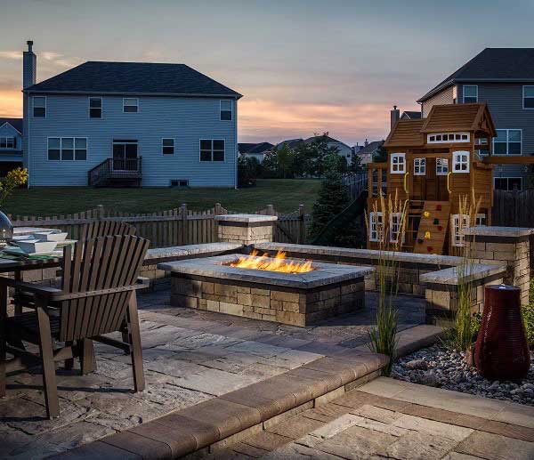 a cozy residential patio with a fireplace