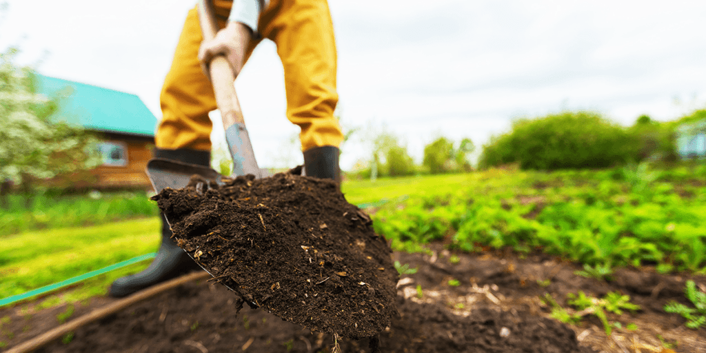 Platt Hill Nursery man digging soil from garden