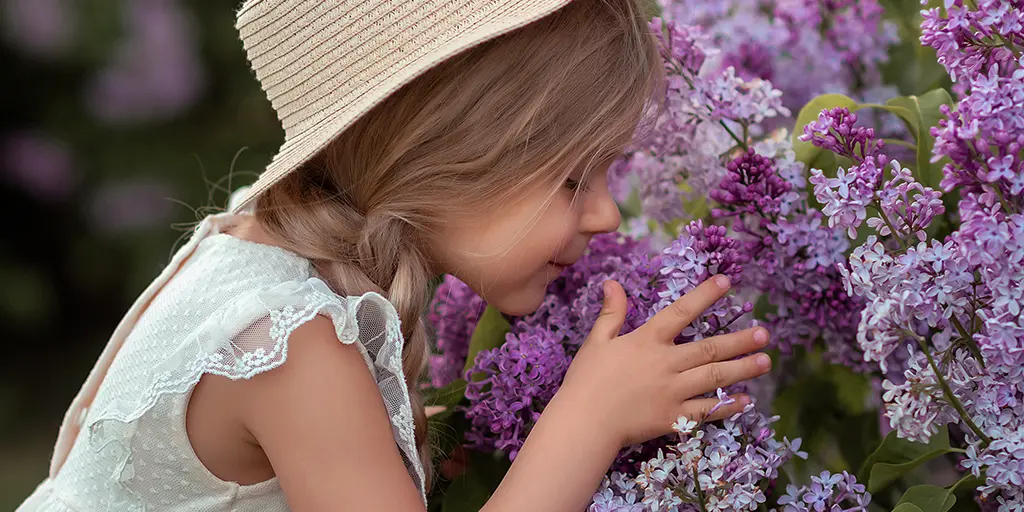 Little Girl Smelling Lilacs
